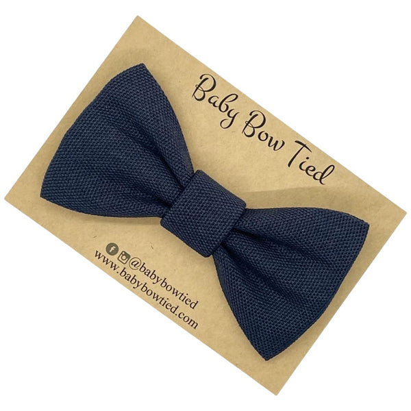 Woven navy clip-on bow tie for babies and boys on a Baby Bow Tied card